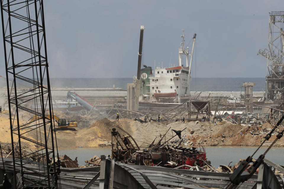 Rescue teams search for missing people near the site of last Tuesday's explosion that hit the seaport of Beirut, Lebanon, Sunday, Aug. 9, 2020. (AP Photo/Hassan Ammar)