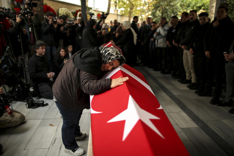 Relatives and friends of Arzu Ozsoy and her 15-year-old daughter Yagmur Ucar, who died in Sunday's explosion occurred on Istiklal avenue, attend their funeral in Istanbul, Turkey, Monday, Nov. 14, 2022. (AP Photo/Emrah Gurel)