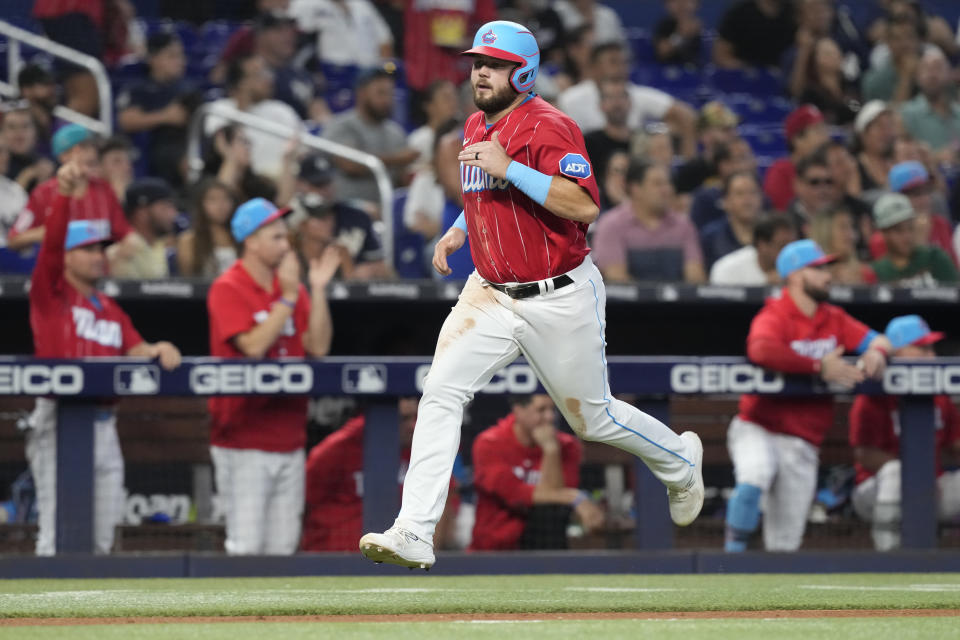 Miami Marlins' Jake Burger runs to score on a single by Joey Wendle during the fourth inning of a baseball game against the New York Yankees, Saturday, Aug. 12, 2023, in Miami. (AP Photo/Marta Lavandier)