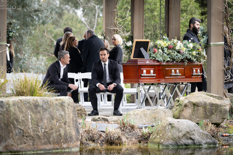 paul robinson, aaron brennan and lucy robinson at david tanaka's funeral in neighbours