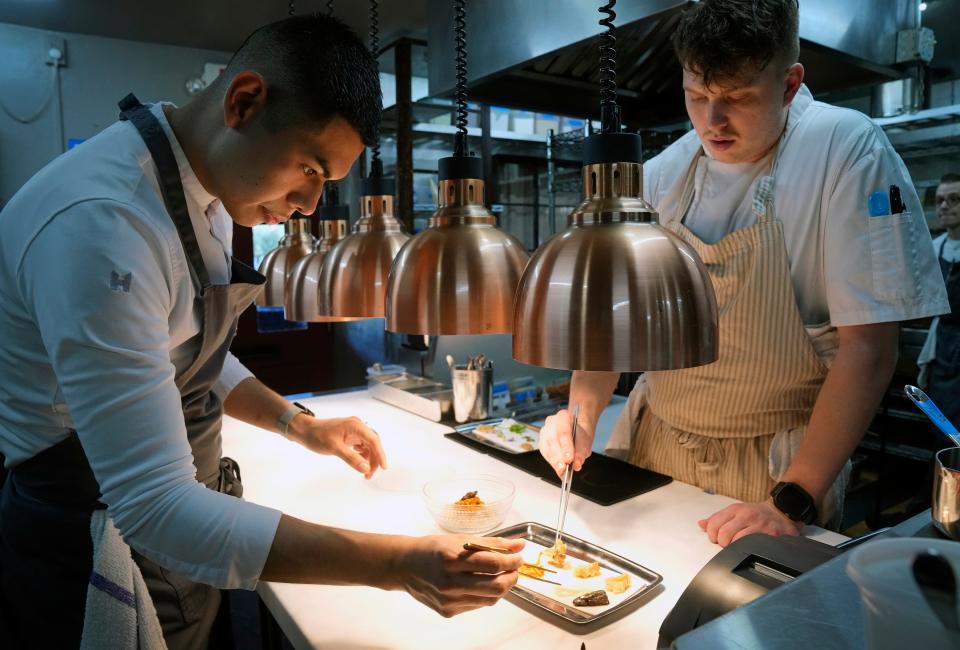 Chef David Brito (left) and Chef Jacob Hilliard prepare food in the Reserve kitchen on Jan. 13, 2023, in Scottsdale.