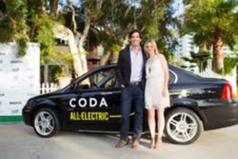 Amy Smart and her husband with a CODA car.