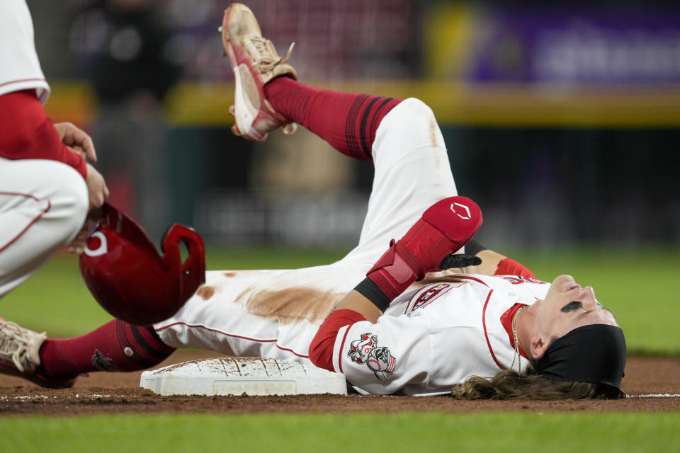 Cincinnati Reds' TJ Friedl is injured while attempting to steal third base during the third inning of a baseball game against the Chicago Cubs, Monday, Oct. 3, 2022, in Cincinnati. (AP Photo/Jeff Dean)