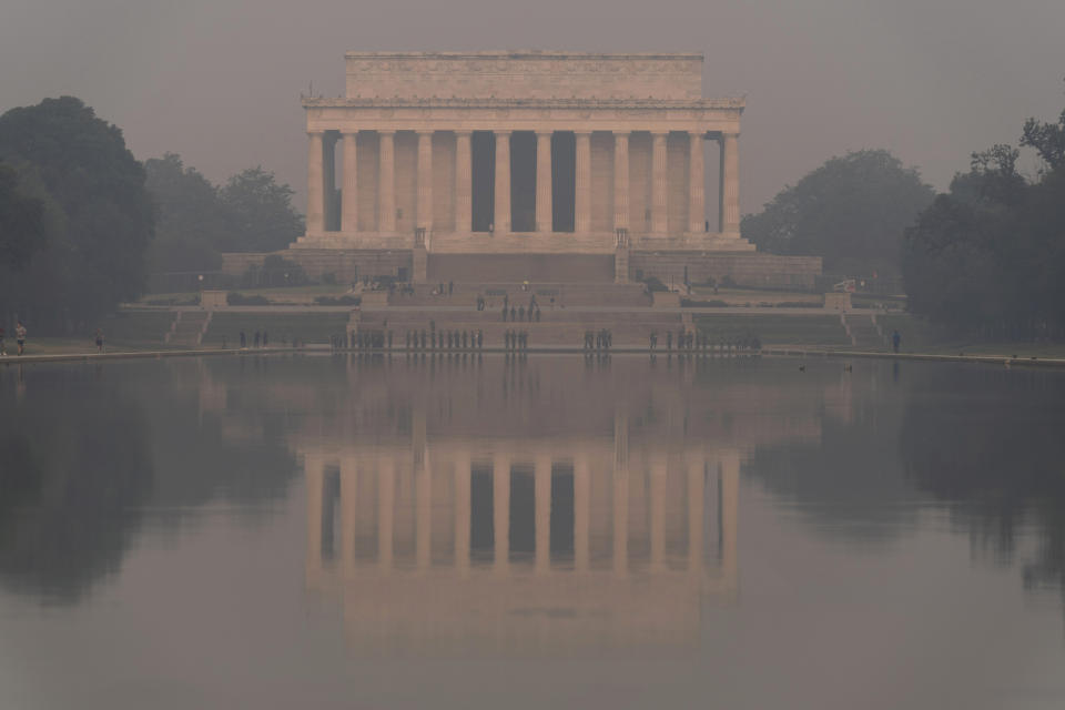 The Lincoln Memorial is seen reflected in the reflecting pool at the national mall with a thick layer of smoke covering, on Thursday, June 8, 2023, in Washington. Intense Canadian wildfires are blanketing the northeastern U.S. in a dystopian haze, turning the air acrid, the sky yellowish gray and prompting warnings for vulnerable populations to stay inside. (AP Photo/Jose Luis Magana)