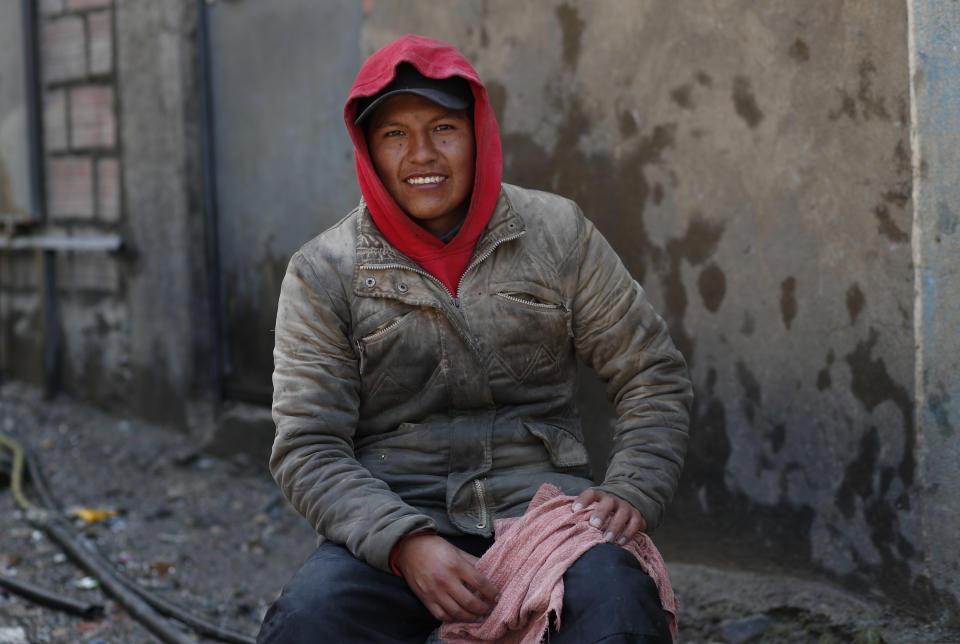 In this Oct. 13, 2019 photo, car washer Nicolas Choque poses for a portrait in La Paz, Bolivia. "I am thinking in a real change because I think that Evo Morales has already done what he had to do and now he has to leave by the big door, like a good President," Choque said. Bolivian voters will decide Sunday whether they will seek change after nearly 14 years under President Evo Morales or allow him to continue to consolidate power in the most contested election of his political career. (AP Photo/Juan Karita)