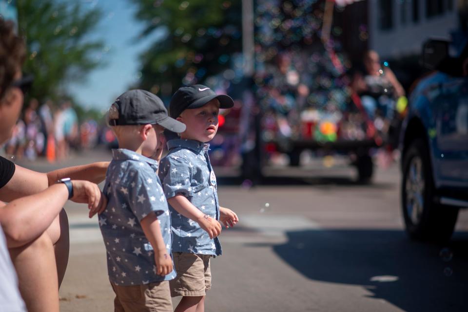 Mason and Miles Heiberger, both 2, sat at the corner of 10th Street and Phillips Avenue awaiting the fire trucks during their first-ever Fourth of July Parade in Sioux Falls on Monday, July 4, 2022.