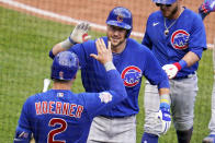 Chicago Cubs' Patrick Wisdom, center, celebrates as he returns to the dugout after hitting a three-run home run off Pittsburgh Pirates relief pitcher Manny Banuelos during the fifth inning of a baseball game in Pittsburgh, Sunday, Sept. 25, 2022. (AP Photo/Gene J. Puskar)
