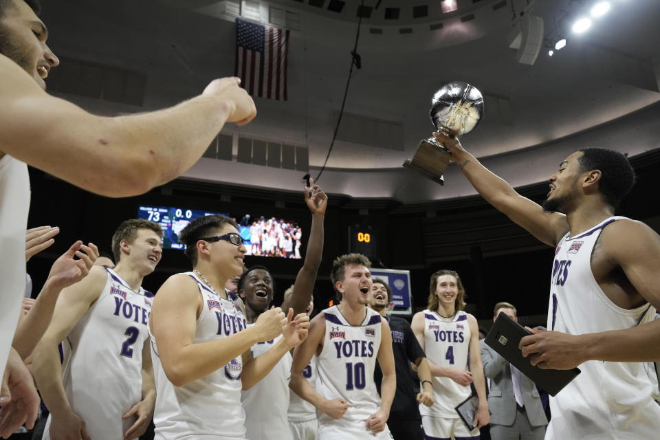 College of Idaho players celebrate after their NAIA men's national championship college basketball game against Indiana Tech Saturday, March 18, 2023, in Kansas City, Mo. College of Idaho won 73-71. (AP Photo/Charlie Riedel)