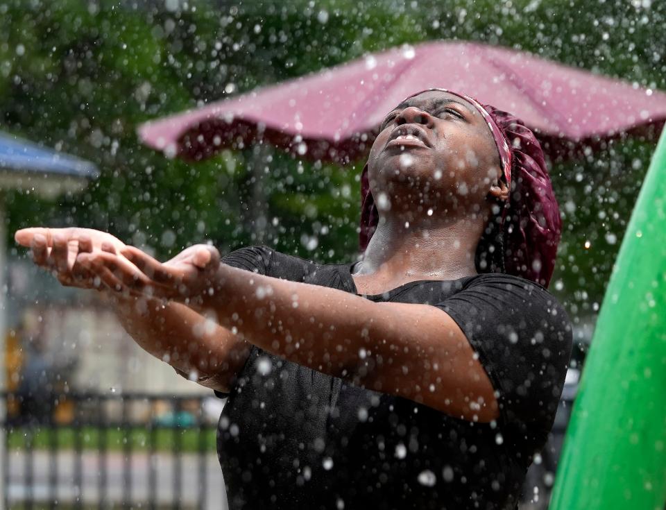 June 17, 2024; Columbus, Ohio, USA; 
Diy’Nastee Ball, 14, holds her hands out in the spray of water Monday afternoon on the splash pad at Blackburn Community Center.