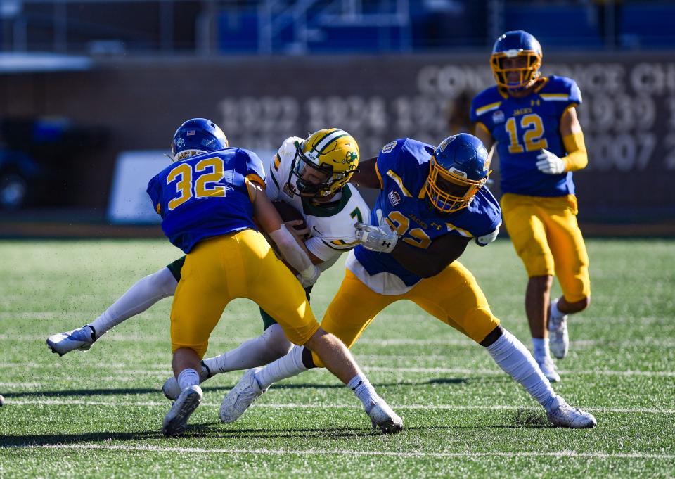 North Dakota State's Cam Miller is tackled by multiple South Dakota State players in the annual Dakota Marker game on Saturday, November 6, 2021 at Dana J. Dykhouse Stadium in Brookings.