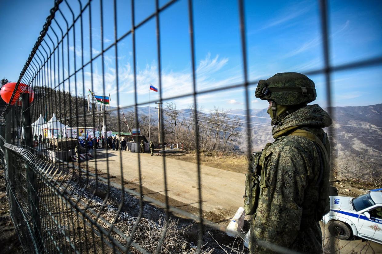 A Russian peacekeeper guards the Lachin corridor connecting Nagorno-Karabakh to Armenia. <a href="https://www.gettyimages.com/detail/news-photo/russian-peacekeeper-guards-the-lachin-corridor-the-armenian-news-photo/1245836870?adppopup=true" rel="nofollow noopener" target="_blank" data-ylk="slk:Tofik Babayev/AFP via Getty Images;elm:context_link;itc:0;sec:content-canvas" class="link ">Tofik Babayev/AFP via Getty Images</a>