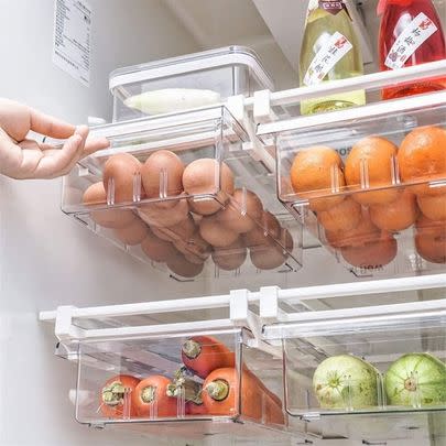 A set of extra mini drawers that clip onto your refrigerator shelves