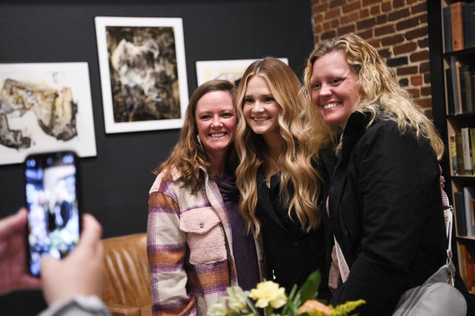 Author Audra McElyea, center, poses for a photo with fans Brooke Lakin and Carol Davis at her book launch at Addison’s Bookstore on Gay Street, Friday, Jan. 5, 2024.
