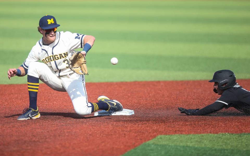 Louisville's Christian Knapczyk steals second as Michigan's Ted Burton tries to make the tag at the 2022 NCAA Regional at Jim Patterson Stadium Saturday. June 4, 2022
