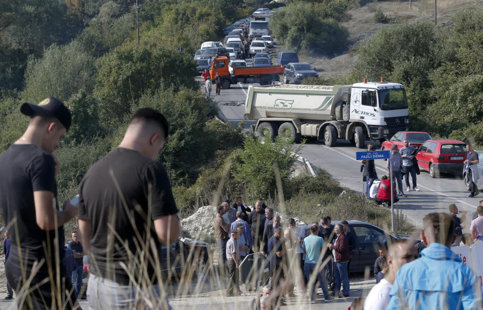 Trucks are parked on the road at a roadblock in Vojtesh, Kosovo, Sunday, Sept. 9, 2018. Kosovo Albanians burned tires and blocked roads with wooden logs, trucks and heavy machinery on a planned route by Serbia's President Aleksandar Vucic who was trying to reach the village of Banje while visiting Serbs in the former Serbian province. (AP Photo/Visar Kryeziu)