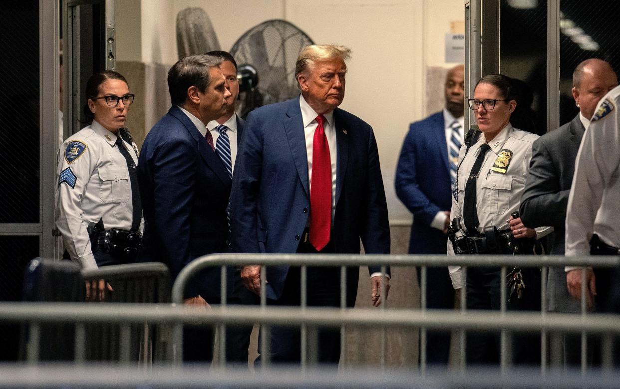 Donald Trump returns from a break as jury selection begins in his trial at Manhattan Criminal Court