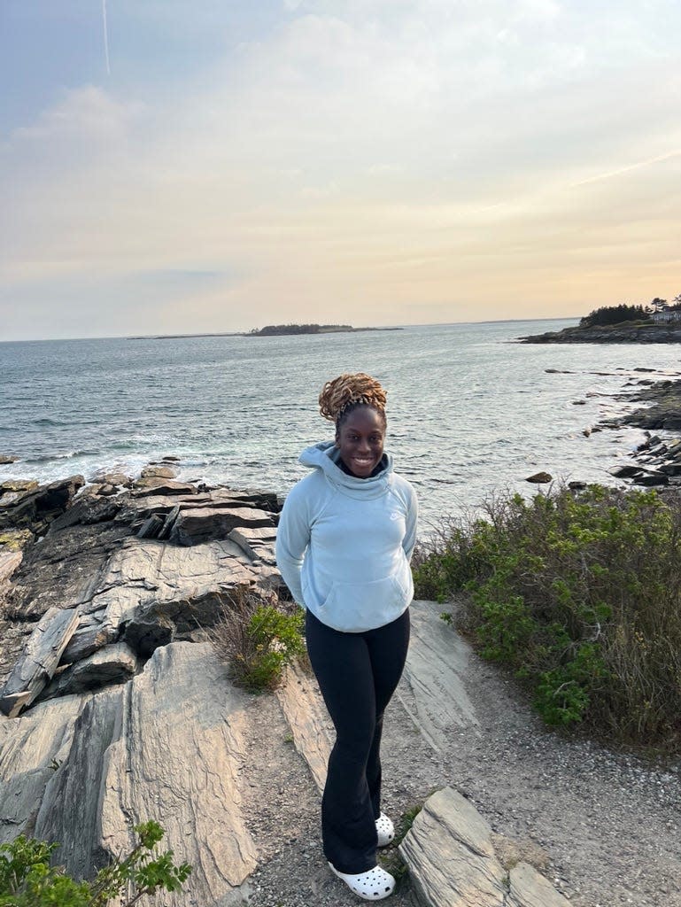 Amara Ifeji, 21, had to teach herself about climate change growing up. Here she stands at Two Lights State Park in Cape Elizabeth, Maine. She fell in love with the environment after visiting Acadia National Park for the first time at age 10.
