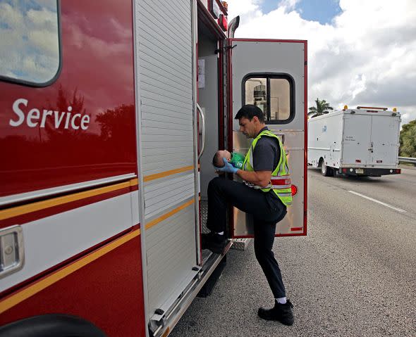 Mandatory Credit: Photo by ZUMA/REX (3588433h)A paramedic with Miami Fire-Rescue transports 5-month-old Sebastian de la Cruz, who had stopped breathing, to the hospital. The baby's aunt performed CPR after pulling her SUV over on the side of the road along Florida state road 836Baby rescued after he stops breathing on a highway, Miami, America - 20 Feb 2014This is the heart-stopping moment an aunt succsessfully performed CPR on her 5-month-old nephew on the side of a road in Miami. Pamela Rauseo was caring for her baby nephew Sebastian de la Cruz when he suddenly stopped breathing and turned blue as she drove along a highway. She leapt out of her vehicle screaming for help with little Sebastian in her arms. Several passers-by stopped, including Miami Herald photographer Al Diaz who quickly ran to alert a nearby policeman in his patrol car. The officer, Amauris Bastidasy, rushed over to help as Pamela began CPR on her nephew. Amauris and fellow Good Samaritan motorist Lucila Godoy also helped with the resuscitation efforts. The tiny youngster, who had been born prematurely, started breathing before stopping for a second time. By then paramedica had arrived and Sebastian was rushed to hospital where he is said to be recovering well.