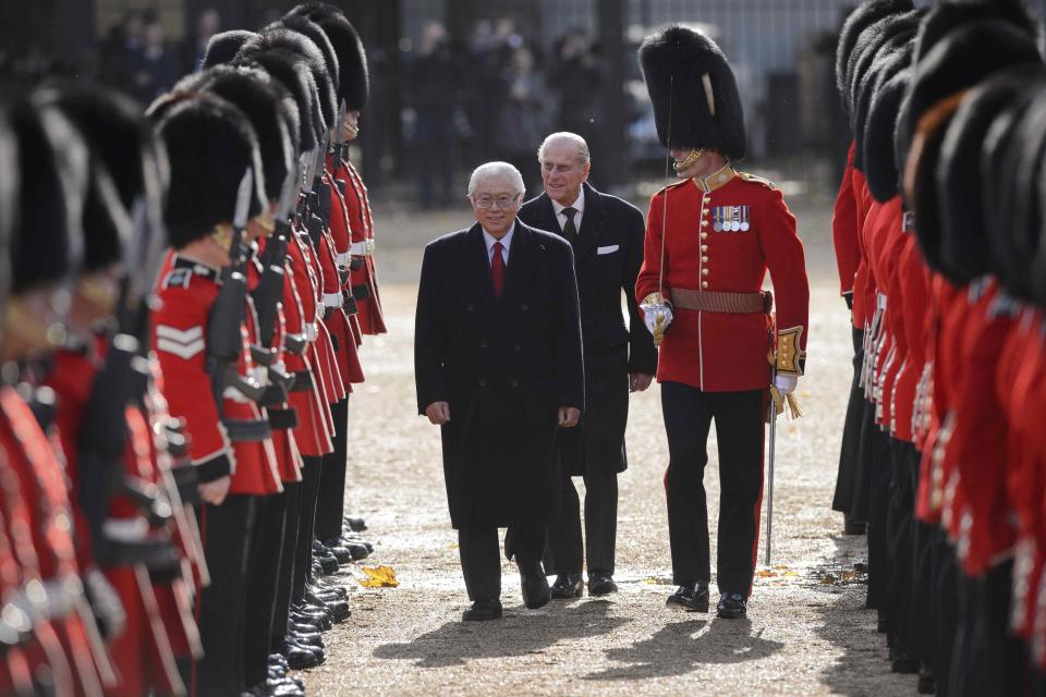 The President of Singapore Tony Tan is followed by Prince Philip as he inspects a Guard of Honour at Horse Guards Parade in London October 21, 2014. The President and his wife will be guests of Queen Elizabeth during the first state visit of a Singapore President to Britain. REUTERS/Leon Neal (BRITAIN - Tags: POLITICS ROYALS MILITARY)