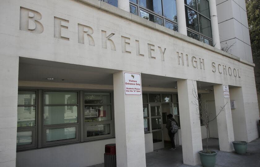A student walks into Berkeley High School in Berkeley, Calif., Thursday, April 11, 2019. The first online election for student government at Berkeley High School became a lesson in more than democracy. Students also learned about vote fraud, hacking and digital privacy after a high school junior who was running for class president cast hundreds of fake online votes for himself. (AP Photo/Jeff Chiu)