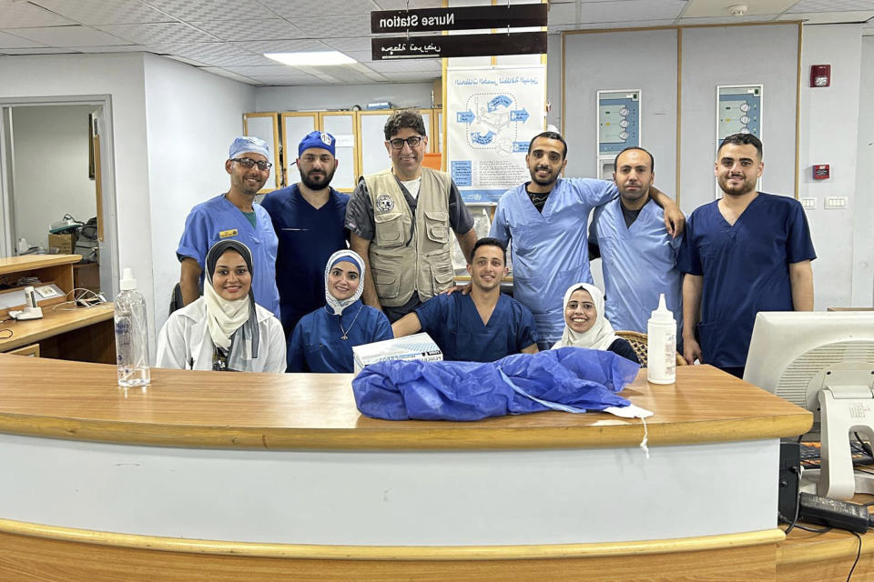 Dr. Ammar Ghanem, an ICU specialist from Detroit volunteering with the Syrian American Medical Society, third from left, poses with a local team of ICU nurses and staff at the European General Hospital on May 6, 2024, in Khan Younis, Gaza, where he has been volunteering since early May. A group of 35 foreign doctors on a volunteer mission to help at the hospital, including 22 Americans, have been trapped in Gaza by Israel’s seizure of the Rafah crossing into Egypt.