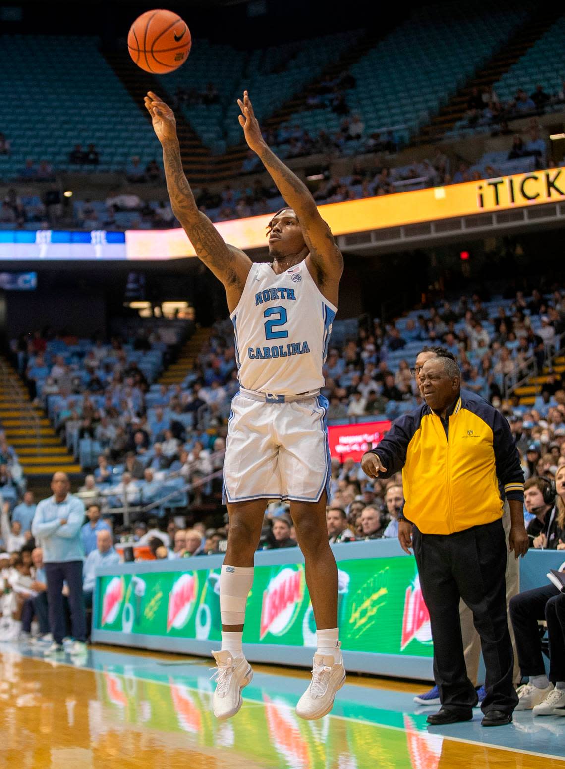 North Carolina’s Caleb Love (2) launches a three-point attempt in front of the Johnson C. Smith bench during an exhibition game on Friday, October 28, 2022 at the Smith Center in Chapel Hill, N.C. Love lead all scores with 20 points.
