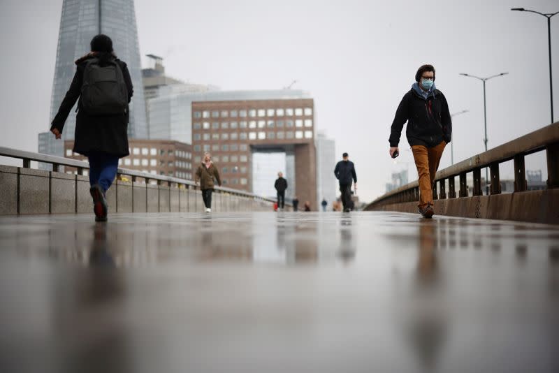 People walk over London Bridge during rush hour, amid the coronavirus disease (COVID-19) outbreak, in London