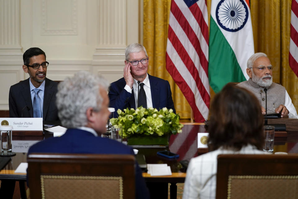 Sundar Pichai, CEO of Google, left, Tim Cook, CEO of Apple, second from left, and India's Prime Minister Narendra Modi listen during a meeting with President Joe Biden and American and Indian business leaders in the East Room of the White House, Friday, June 23, 2023, in Washington. (AP Photo/Evan Vucci)
