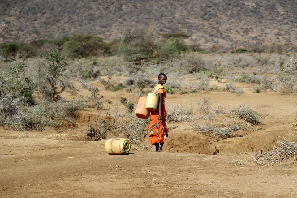 FILE - A Samburu woman fetches water during a drought in Loolkuniyani Primary School, Samburu County, Kenya, Oct. 16, 2022. Tropical Cyclone Freddy, which has already caused 21 deaths and displaced thousands of others in Madagascar and Mozambique, is set to make landfall in Mozambique again, Friday, March 10, 2023. Meteorologists told The Associated Press the uneven and devastating water distribution across Africa’s eastern states is caused by natural weather systems and exacerbated by human-made climate change with cyclones sucking up water that would otherwise be destined for nations further north. (AP Photo/Brian Inganga, File)