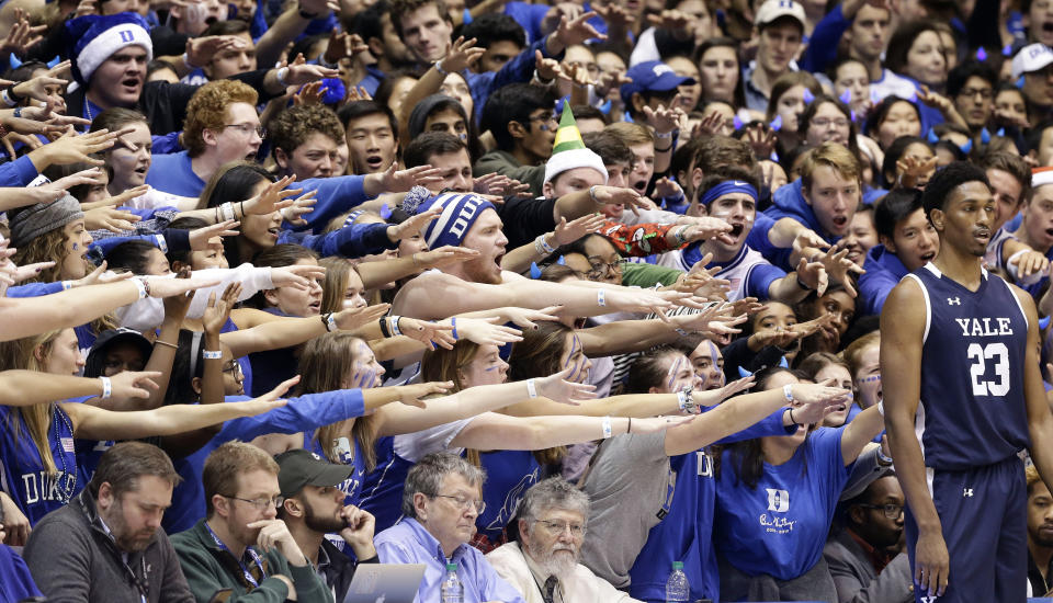 FILE - In this Dec. 8, 2018, file photo, Duke fans cheer as Yale's Jordan Bruner (23) waits to inbound the ball during the first half of an NCAA college basketball game in Durham, N.C. As lock-downs are lifted, restrictions on social gatherings eased and life begins to resemble some sense, sports are finally starting to emerge from the coronavirus pandemic. Many sports business experts believe those hardy fans will be the first to return. (AP Photo/Gerry Broome, File)