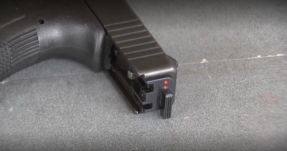 A handgun with an illegal switch attached / Credit: CBS Dallas