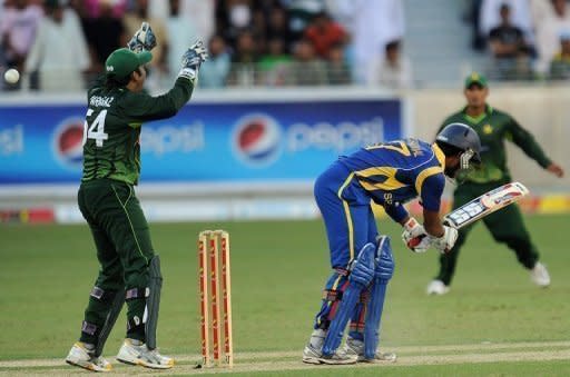 Pakistan's wicketkeeper Sarfraz Ahmed (left) successfully appeals for a Leg Before Wicket (LBW) decision against Sri Lankan batsman Dinesh Chandimal during their One Day International match in Dubai. Leg-spinner Shahid Afridi capped an excellent return to international cricket with three wickets as Pakistan thumped Sri Lanka by eight wickets in the first day-night match