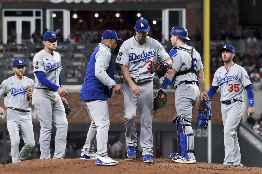 Atlanta, GA - October 17: Los Angeles Dodgers manager Dave Roberts, left, relieves starting pitcher Max Scherzer during the fifth inning in game two in the 2021 National League Championship Series against the Atlanta Braves at Truist Park on Sunday, Oct. 17, 2021 in Atlanta, GA.(Wally Skalij / Los Angeles Times)