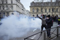 Youths gesture during a demonstration against plans to push back France's retirement age, Tuesday, Jan. 31, 2023 in Paris. Labor unions aimed to mobilize more than 1 million demonstrators in what one veteran left-wing leader described as a "citizens' insurrection." The nationwide strikes and protests were a crucial test both for President Emmanuel Macron's government and its opponents. (AP Photo/Thibault Camus)