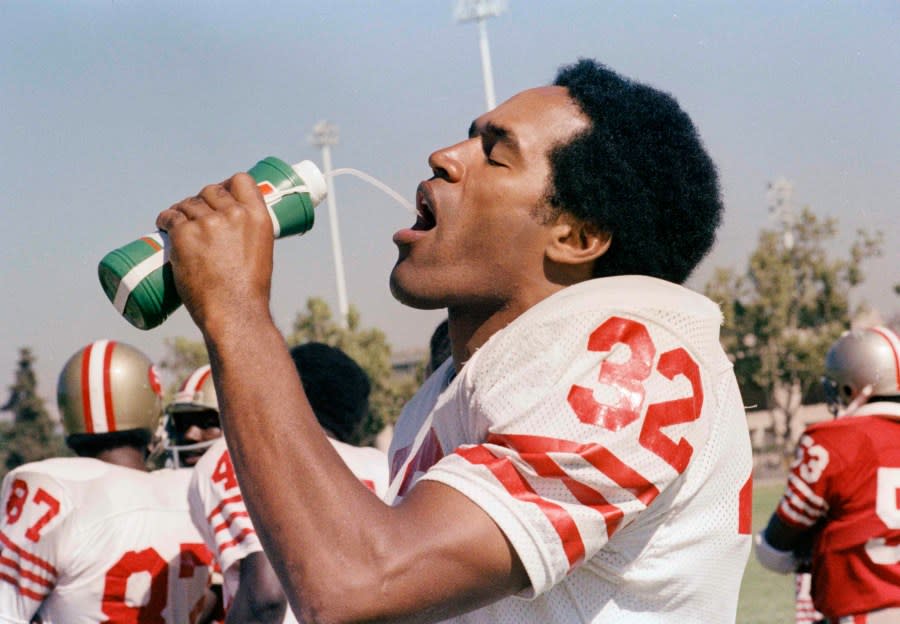 FILE – In this Aug. 1, 1978. file photo, O.J. Simpson of the San Francisco 49ers is shown on the field drinking water in San Francisco. O.J. Simpson’s release from a Nevada prison turns another page in one of the most dramatic falls from grace in American pop culture history. A beloved college and pro football hero in the 1960s and ’70s, Simpson went on to become a movie star, sports commentator and TV pitchman in the years before the 1994 killings of his ex-wife and her friend in Los Angeles. A Nevada prison official said early Sunday, Oct. 1, 2017, O.J. Simpson, the former football legend and Hollywood star, has been released from a Nevada prison in Lovelock after serving nine years for armed robbery. (AP Photo, File)