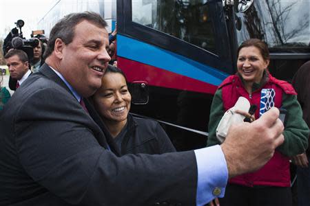 New Jersey Governor Chris Christie (L) takes a photo with a woman s he greets supporters after casting his vote during the New Jersey governor election in Mendham Township, New Jersey, November 5, 2013. REUTERS/Eduardo Munoz