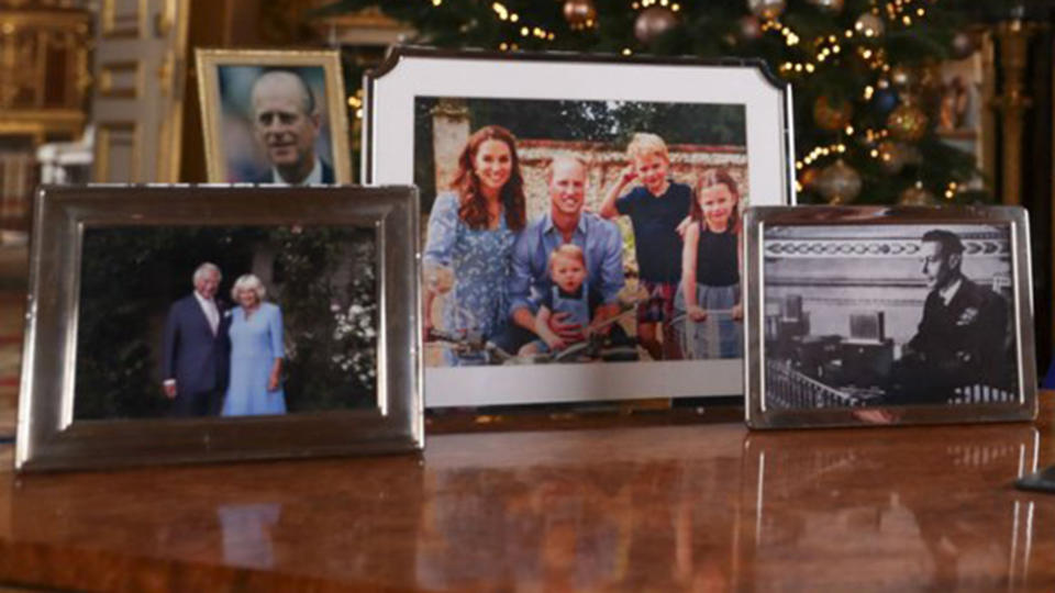 Photo frames with photos including Charles and Camilla, a family snap on a vintage motorbike of William, Kate, George, Charlotte and Louis and his family, and a single shot of Prince Phillip and the Queen's father King George VI. 