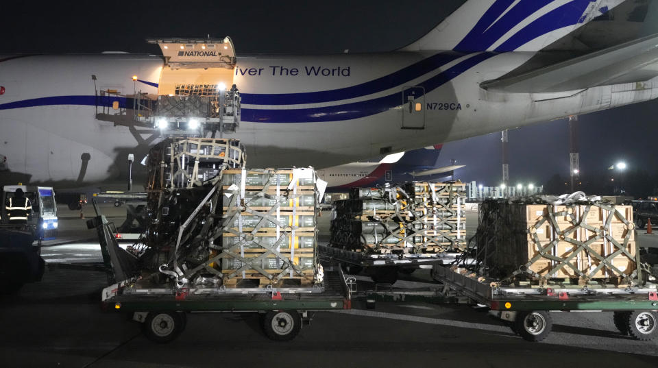 Workers unload a shipment of military aid delivered as part of the United States of America's security assistance to Ukraine, at the Boryspil airport, outside Kyiv, Ukraine, Tuesday, Jan. 25, 2022. A new batch of US security assistance provided to Ukraine, including equipment and ammunitions, arrives at the Boryspil airport. The U.S. moves are being done in tandem with actions by other NATO member governments to bolster a defensive presence in Eastern Europe. (AP Photo/Efrem Lukatsky)