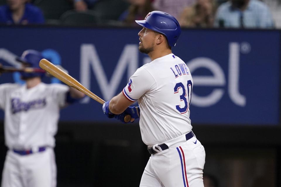 Texas Rangers' Nathaniel Lowe watches his game-ending,two-run home run against the Los Angeles Angels in the 10th inning of a baseball game Wednesday, May 18, 2022, in Arlington, Texas. (AP Photo/Tony Gutierrez)