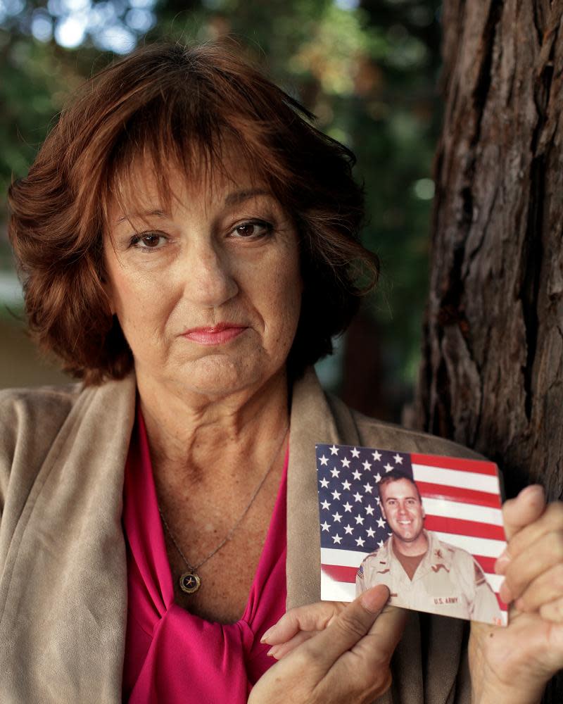 Karen Meredith holds a photograph of her son, Army 1st Lt Kenneth Michael Ballard, who died in Iraq in 2004.