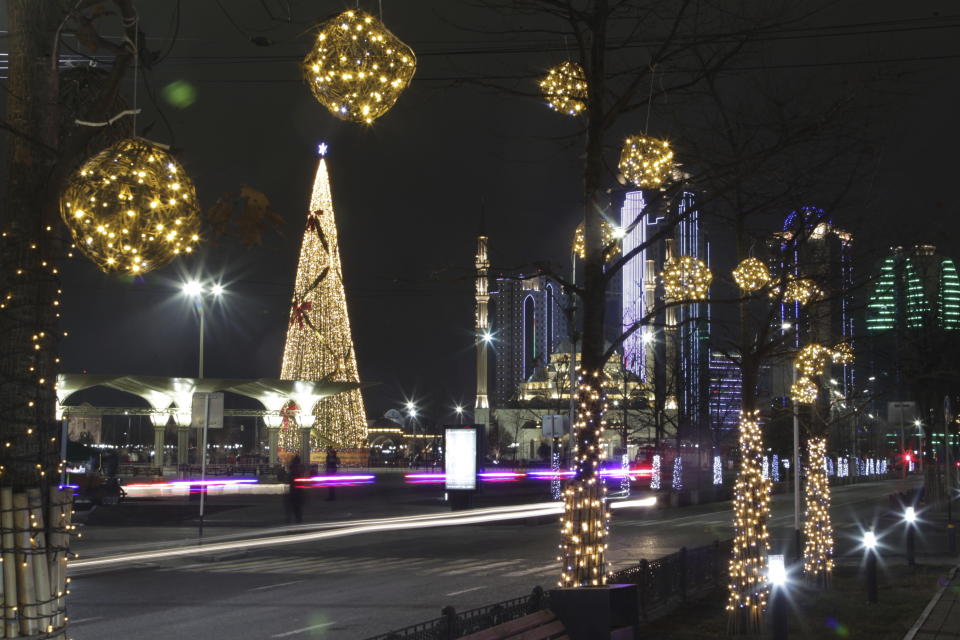 A square decorated for New Year celebrations is seen nearly deserted and without the Holiday Market due to the virus-related restrictions prior to New Year's celebrations in Grozny, Russia, Thursday, Dec. 31, 2020. (AP Photo/Musa Sadulayev)