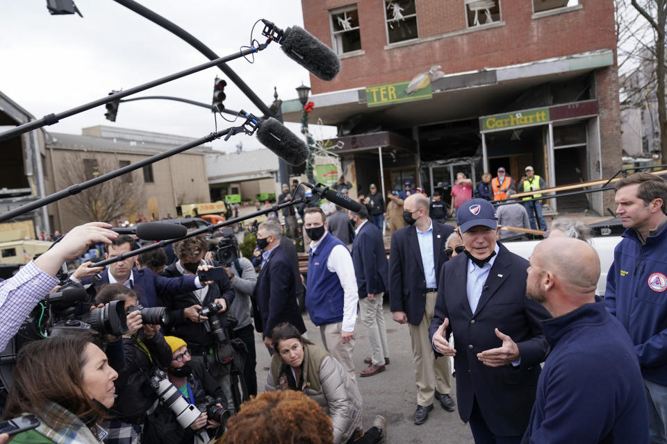 President Joe Biden speaks with members of the media as he surveys storm damage from tornadoes and extreme weather in Mayfield, Ky., Wednesday, Dec. 15, 2021. Kentucky Gov. Andy Beshear is at right. (AP Photo/Andrew Harnik)