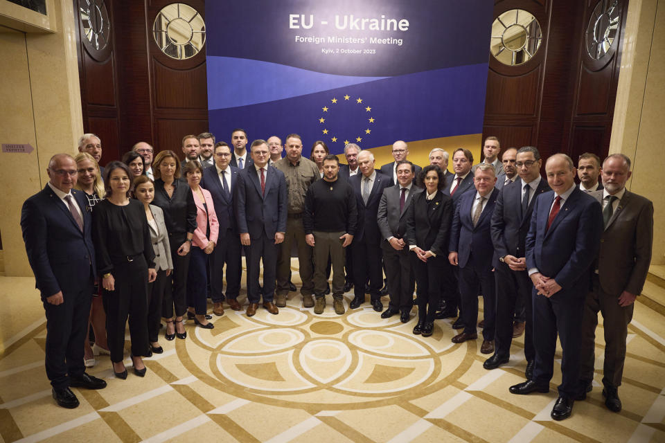 Ukrainian President Volodymyr Zelenskyy, center, poses for photo with participants of the informal EU Foreign Ministers meeting in Kyiv, Ukraine, Monday, Oct. 2, 2023. Some of Europe's top diplomats have gathered in Kyiv in a display of support for Ukraine's fight against Russia's invasion as signs emerge of political strain in Europe and the United States about the war. (Ukrainian Presidential Press Office via AP)