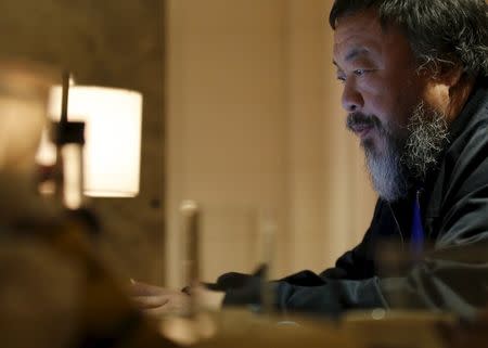 Dissident Chinese artist Ai Weiwei uses his laptop after an interview with Reuters at the hotel he is staying at in Beijing, March 24, 2015. REUTERS/Kim Kyung-Hoon