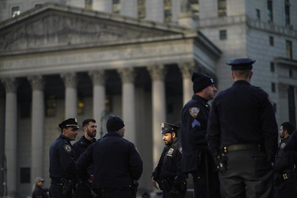 New York Police officers wait for instructions around the courthouse ahead of former President Donald Trump's anticipated indictment on Tuesday, March 21, 2023, in New York. A New York grand jury investigating Trump over a hush money payment to a porn star appears poised to complete its work soon as law enforcement officials make preparations for possible unrest in the event of an indictment. (AP Photo/Eduardo Munoz Alvarez)