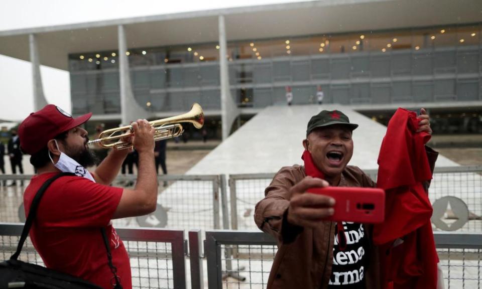 Lula supporters celebrate outside the presidential palace in Brasília on Monday.