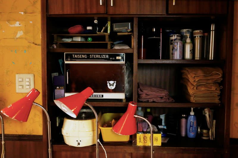 Shelves where masseurs store their personal belongings are seen inside a massage parlour in Taipei