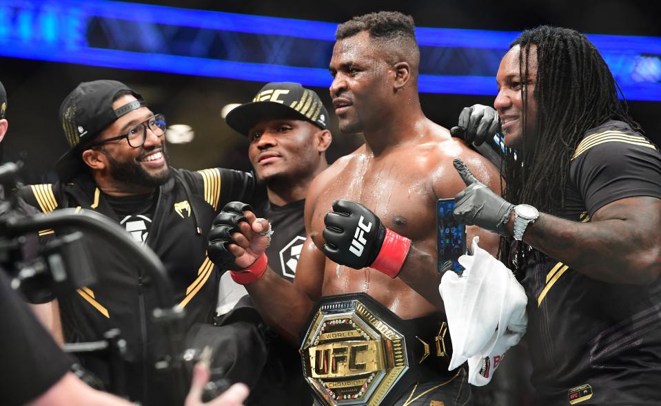 UFC 270 heavyweight world champion Cameroon's Francis Ngannou (C) celebrates victory over France's Ciryl Gane after their fight for the heavyweight title at the Honda Center in Anaheim, California on January 22, 2022. (Photo by Frederic J. BROWN / AFP) (Photo by FREDERIC J. BROWN/AFP via Getty Images)