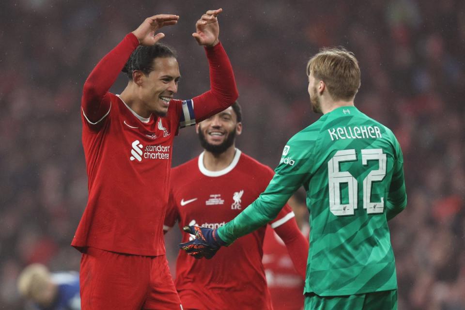 Liverpool’s captain celebrates with Caoimhin Kelleher – the goalkeeper kept the Reds in the game with key saves (AFP via Getty Images)