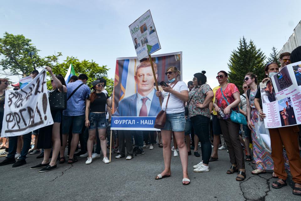 People carry a portrait of Sergei Furgal, the governor of the Khabarovsk region, during an unauthorised rally in his support in the Russian far eastern city of Khabarovsk on July 18, 2020. - Tens of thousands of people rallied on July 18 in Khabarovsk in new protests in support of a popular governor and in a rare show of defiance against the Kremlin. Sergei Furgal was arrested last week on charges of ordering the killings of businessmen 15 years ago. (Photo by Aleksandr YANYSHEV / AFP) (Photo by ALEKSANDR YANYSHEV/AFP via Getty Images)